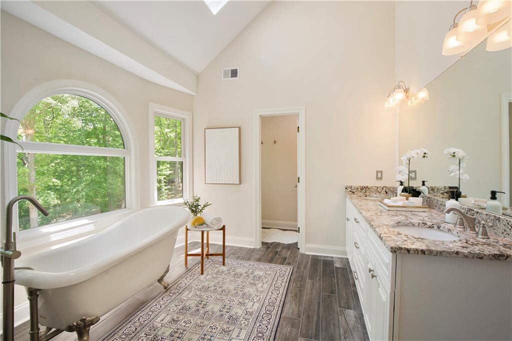 2935 Coles Way Atlanta, GA 30350 - Photo 25 of 56 a spacious bathroom with a granite countertop sink and a large mirror