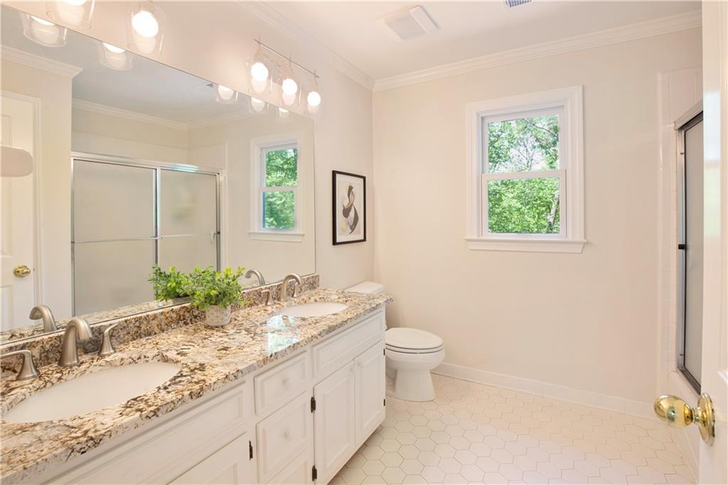 2935 Coles Way Atlanta, GA 30350 - Photo 29 of 56 a bathroom with a granite countertop sink a toilet and a mirror