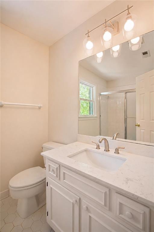2935 Coles Way Atlanta, GA 30350 - Photo 32 of 56 a bathroom with a sink a toilet and mirror