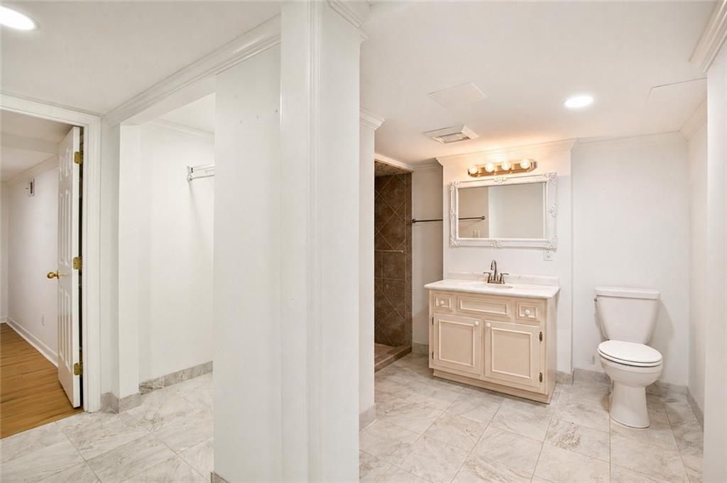 2935 Coles Way Atlanta, GA 30350 - Photo 38 of 56 a spacious bathroom with a toilet sink and a mirror