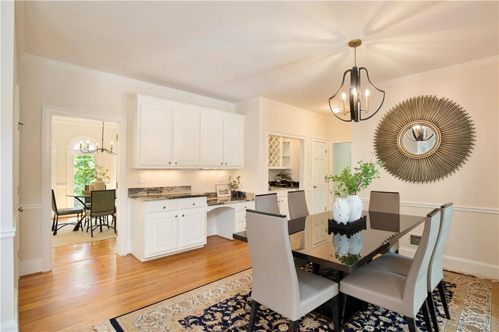 2935 Coles Way Atlanta, GA 30350 - Photo 10 of 56 a dining room with wooden floor a chandelier a wooden table and chairs