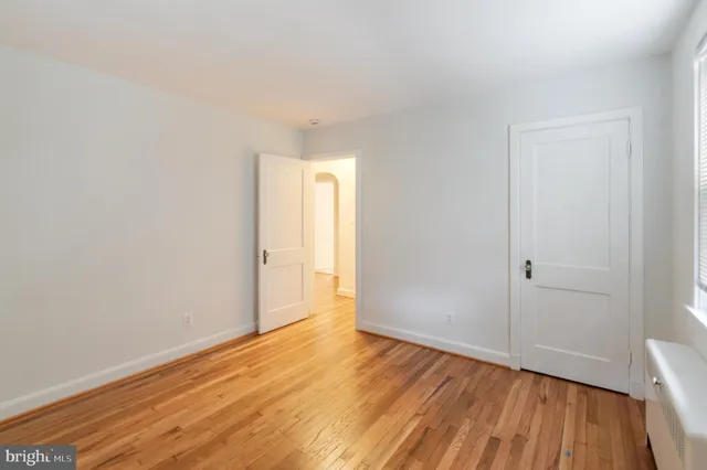 a view of an empty room and wooden floor