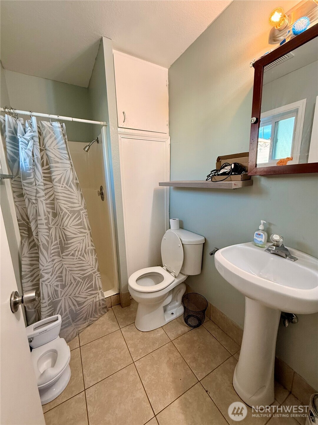 812 Ferry Street Wenatchee, WA 98801 - Photo 13 of 29 a white toilet sitting next to a bathroom sink