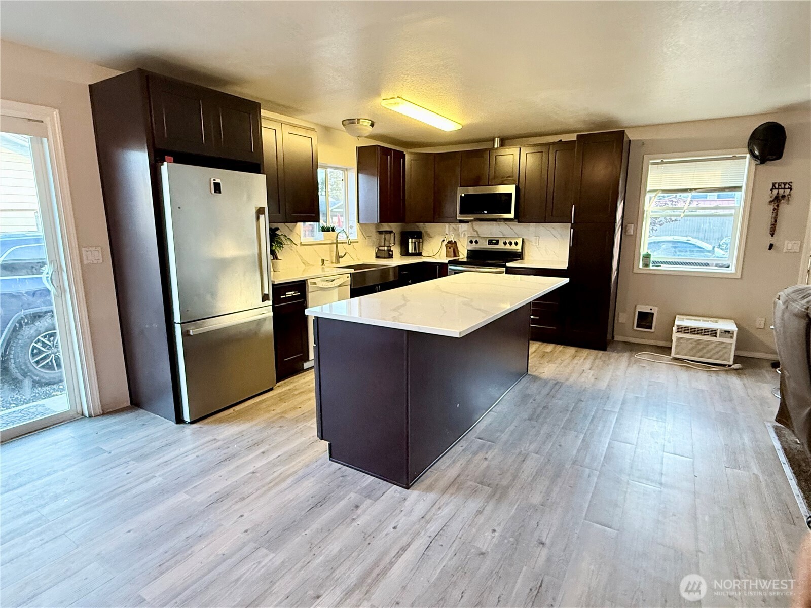 812 Ferry Street Wenatchee, WA 98801 - Photo 23 of 29 a kitchen with stainless steel appliances kitchen island hardwood floor sink stove refrigerator and wooden floor
