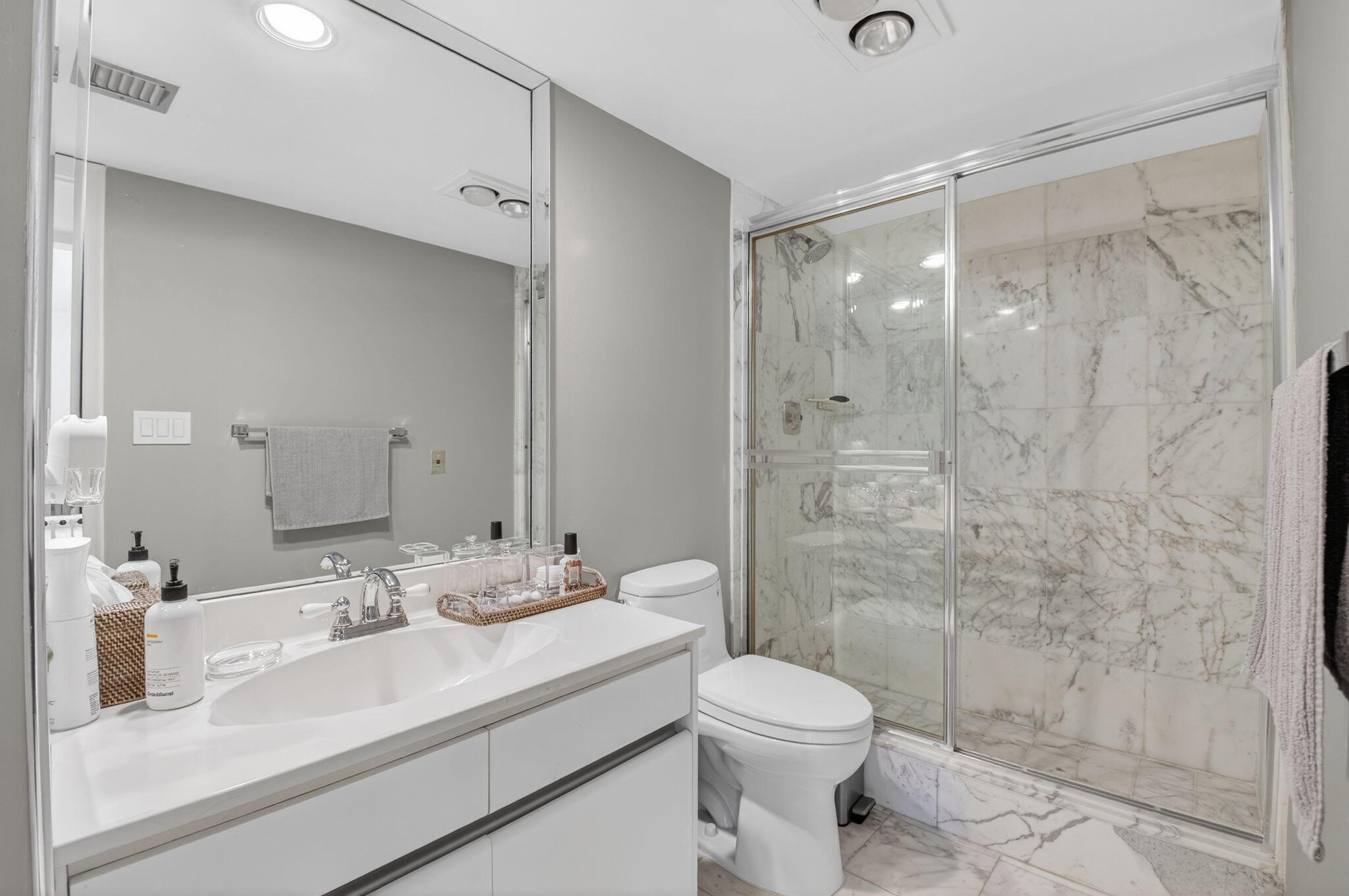7369 Orangewood Lane, Unit 307 Boca Raton, FL 33433 - Photo 15 of 37 a bathroom with a sink a toilet and shower