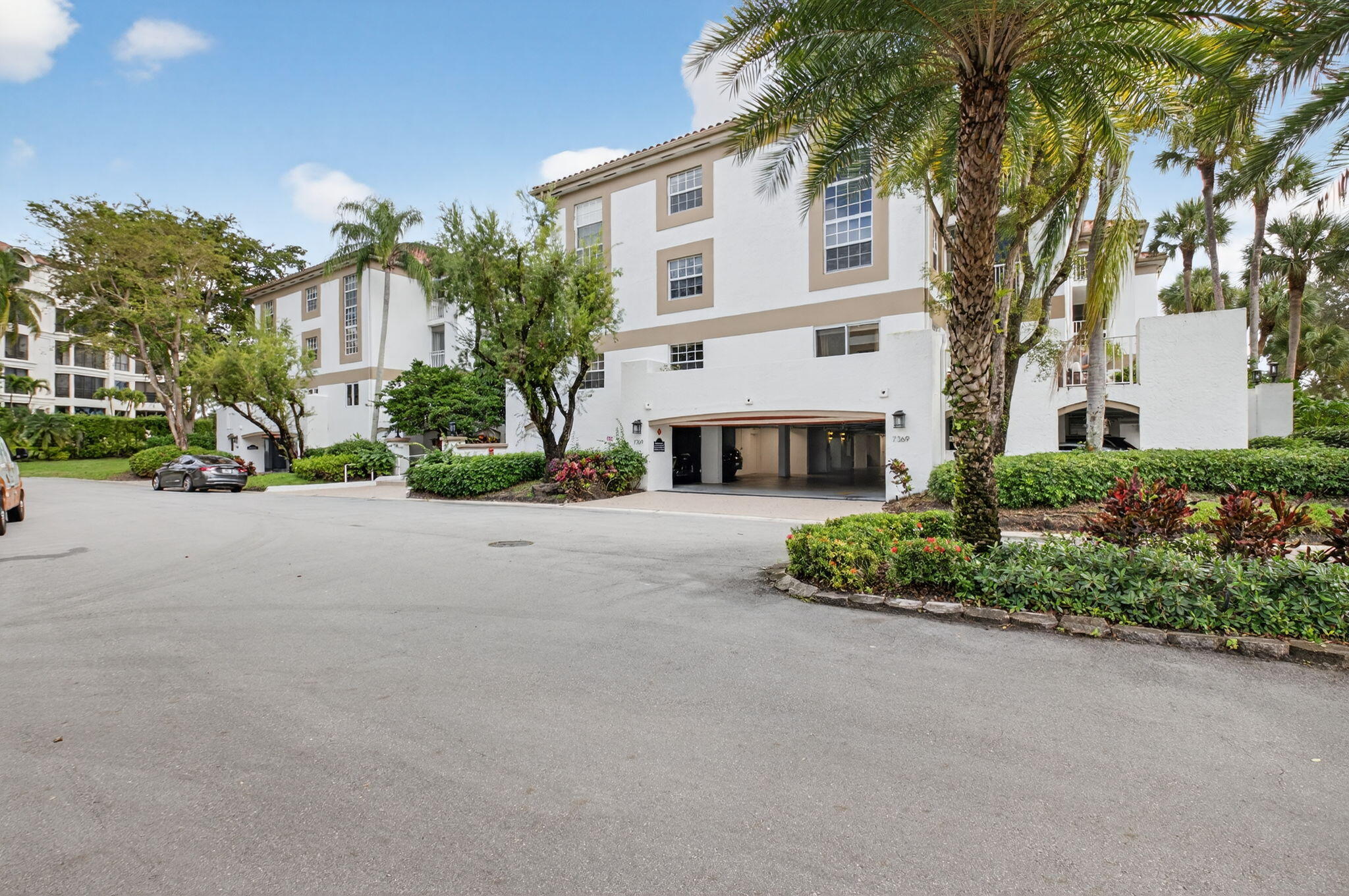 7369 Orangewood Lane, Unit 307 Boca Raton, FL 33433 - Photo 2 of 37 a view of house with outdoor space and trees