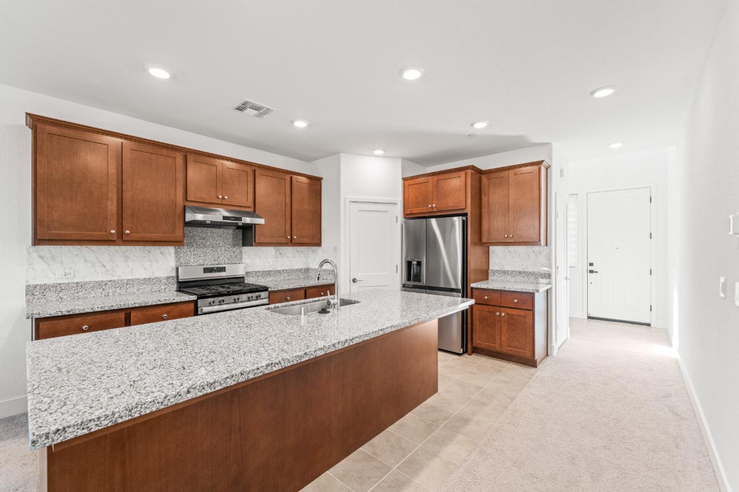 384 Ramos Ranch Road Oakley, CA 94561 - Photo 6 of 39 a large kitchen with stainless steel appliances granite countertop a sink refrigerator stove and microwave