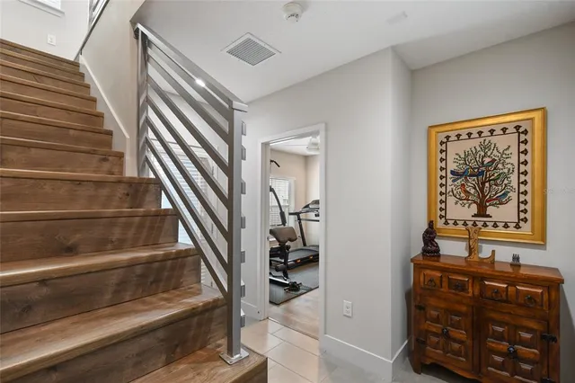 a view of staircase with white walls and a window
