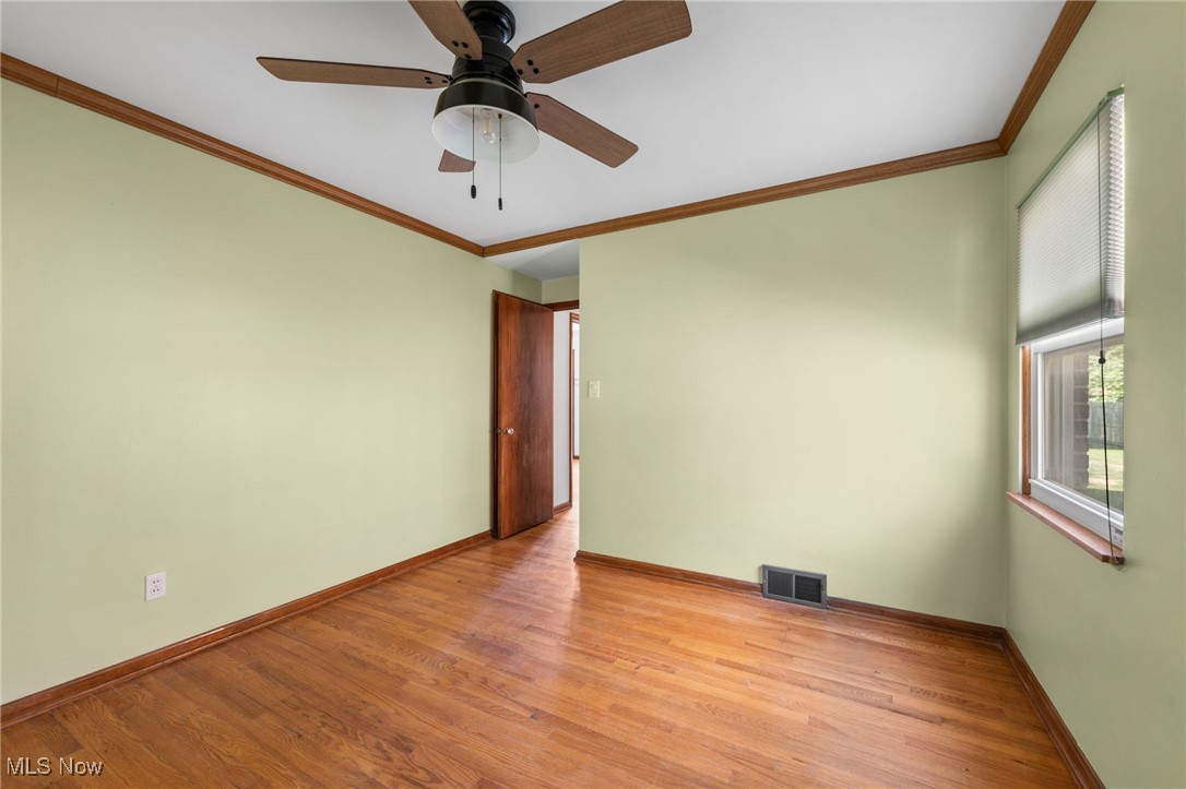 18122 Nottingham Road Cleveland, OH 44119 - Photo 13 of 29 Bedroom with crown molding, wood finished floors, and ceiling fan