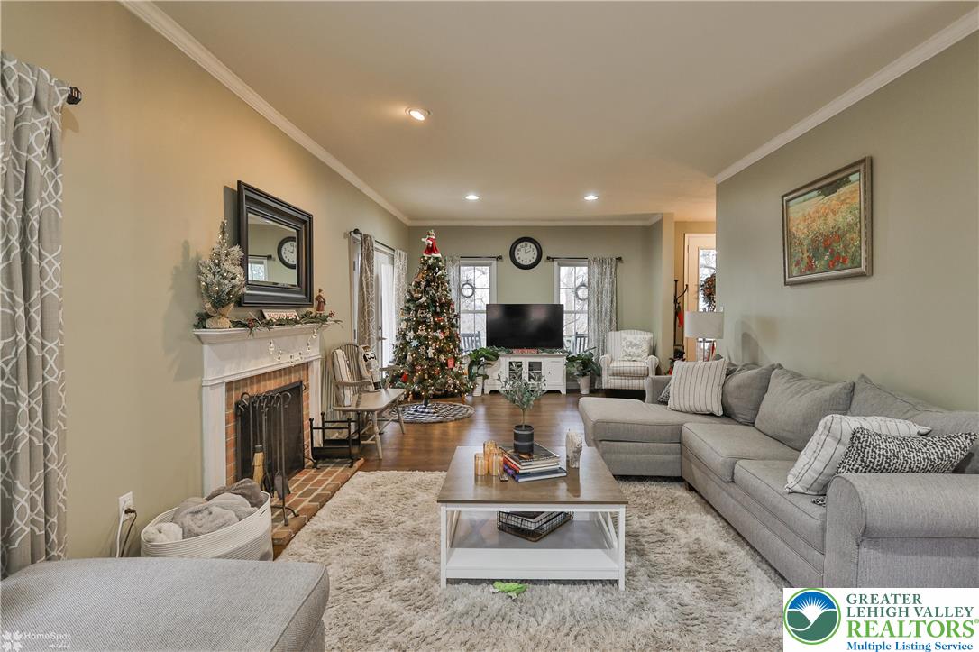 3475 Honeysuckle Road Bethlehem, PA 18015 - Photo 18 of 87 a living room with furniture a fireplace and a flat screen tv