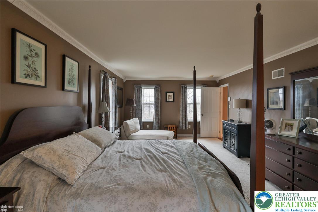 3475 Honeysuckle Road Bethlehem, PA 18015 - Photo 38 of 87 a bedroom with a large bed and a chandelier