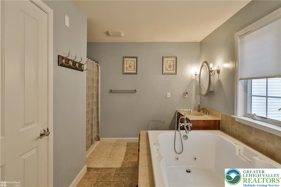 3475 Honeysuckle Road Bethlehem, PA 18015 - Photo 41 of 87 a bathroom with a tub sink and mirror