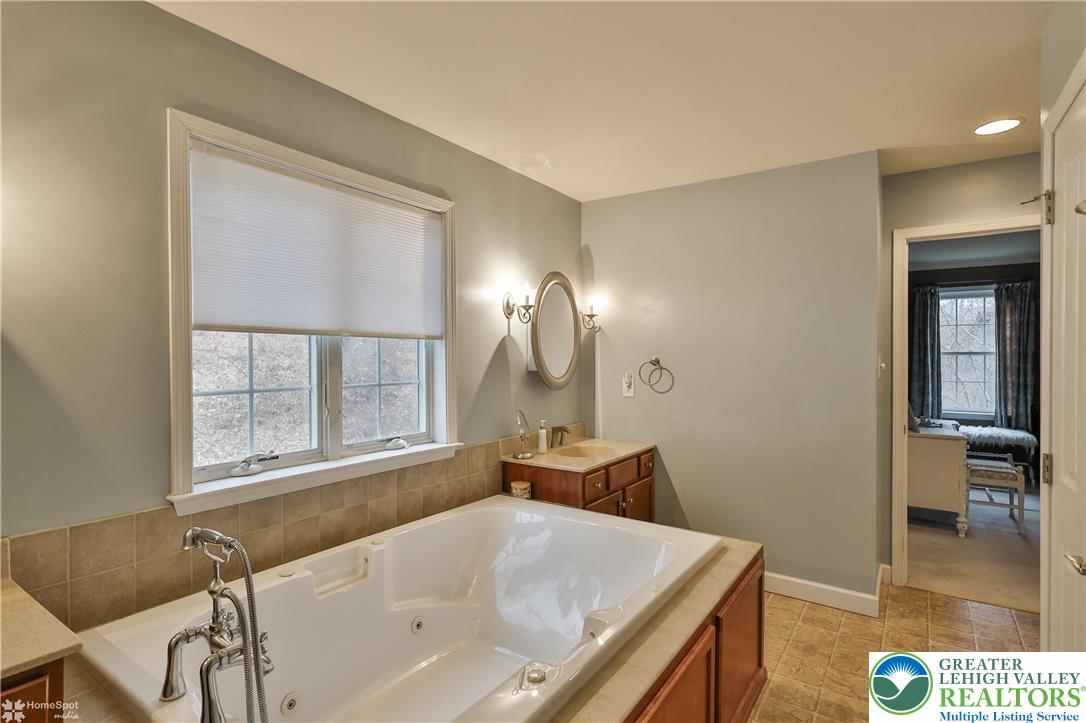 3475 Honeysuckle Road Bethlehem, PA 18015 - Photo 42 of 87 a bathroom with a tub sink and mirror