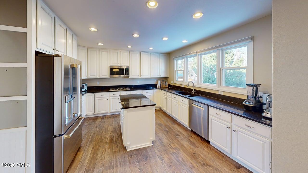 8958 South Forrest Drive Littleton, CO 80126 - Photo 17 of 27 a kitchen with stainless steel appliances a sink a stove a refrigerator and cabinets