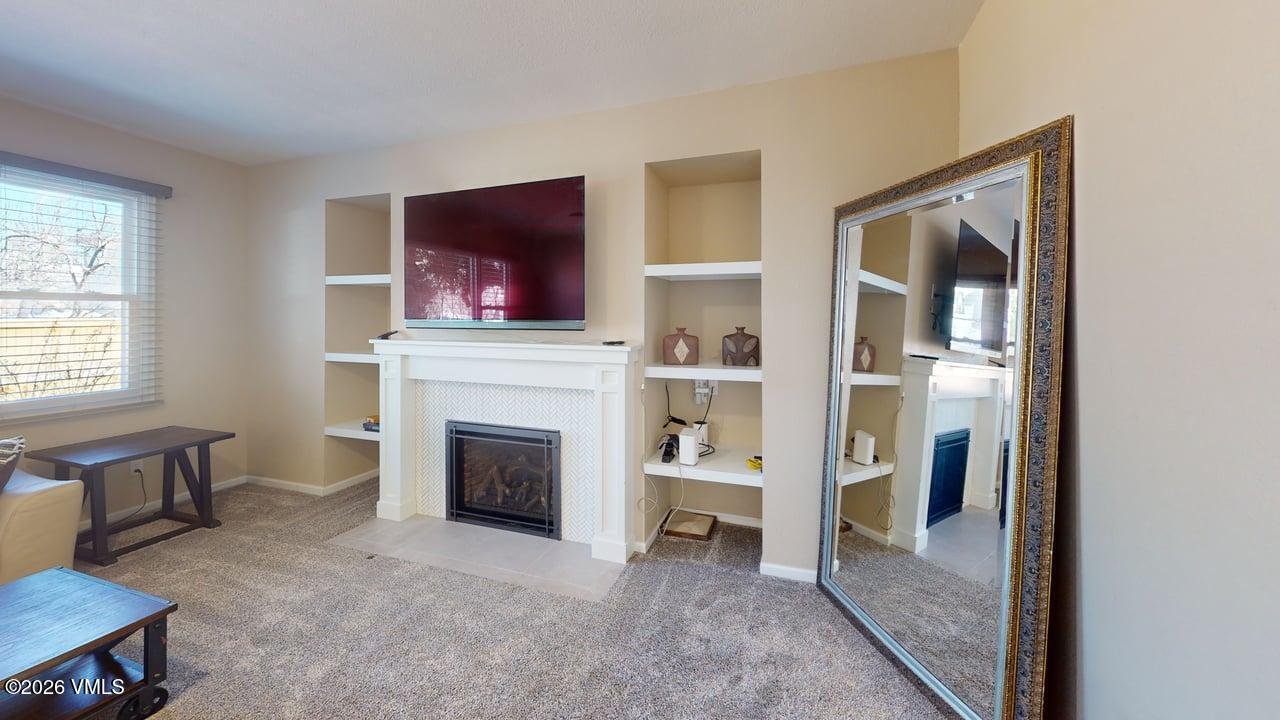 8958 South Forrest Drive Littleton, CO 80126 - Photo 20 of 27 a living room with furniture and a fireplace