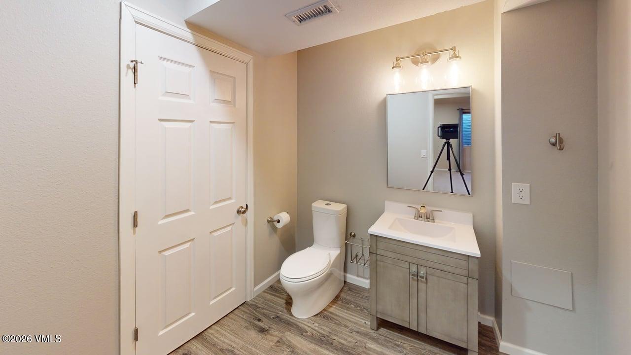 8958 South Forrest Drive Littleton, CO 80126 - Photo 2 of 27 a bathroom with a toilet a sink and mirror