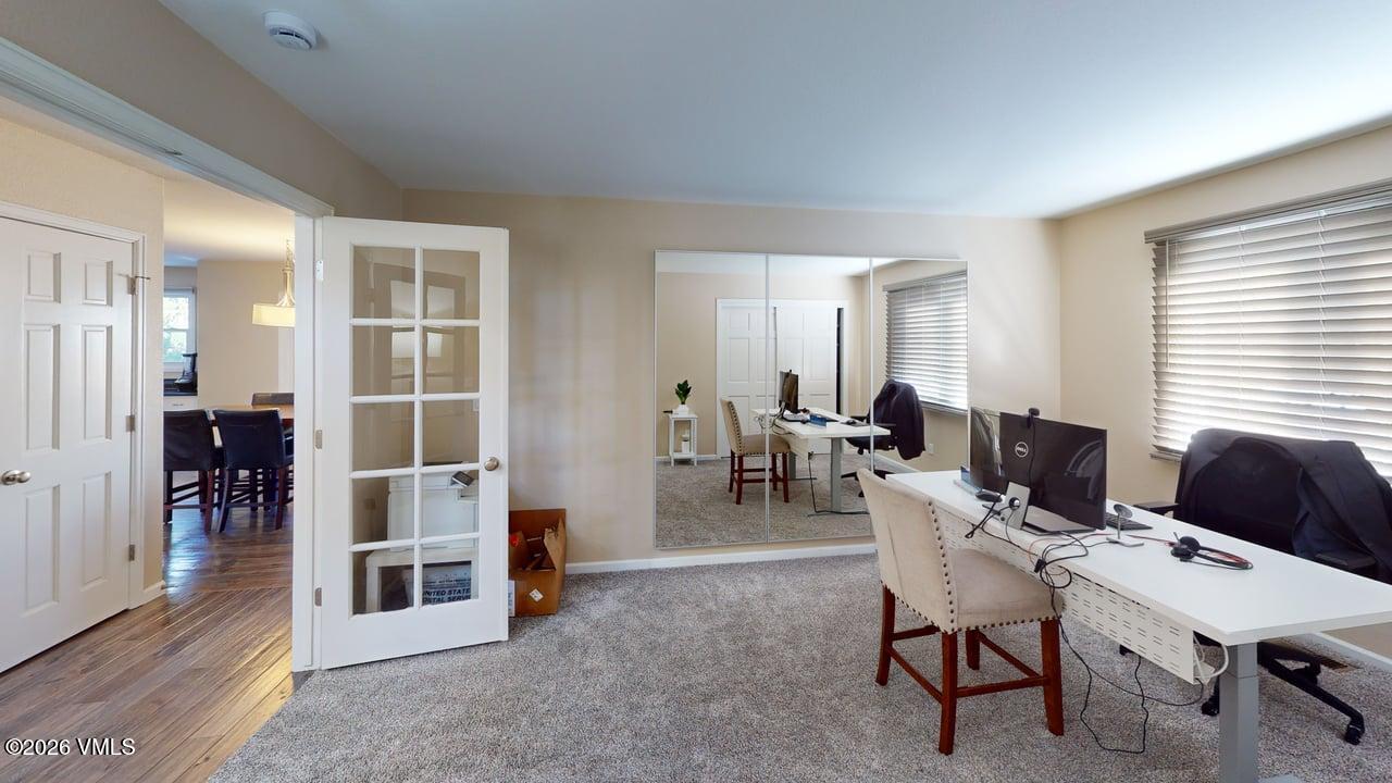 8958 South Forrest Drive Littleton, CO 80126 - Photo 25 of 27 a living room with furniture a wooden floor and a window