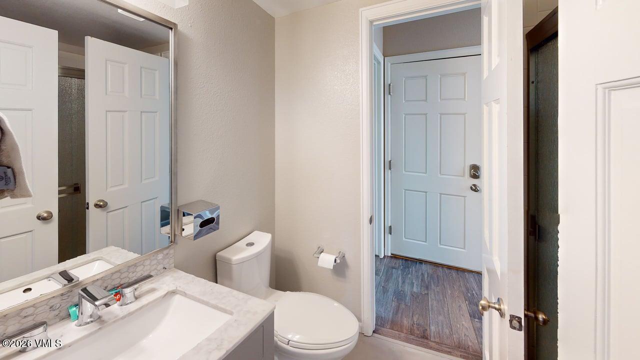 8958 South Forrest Drive Littleton, CO 80126 - Photo 3 of 27 a white toilet sitting next to a bathroom sink