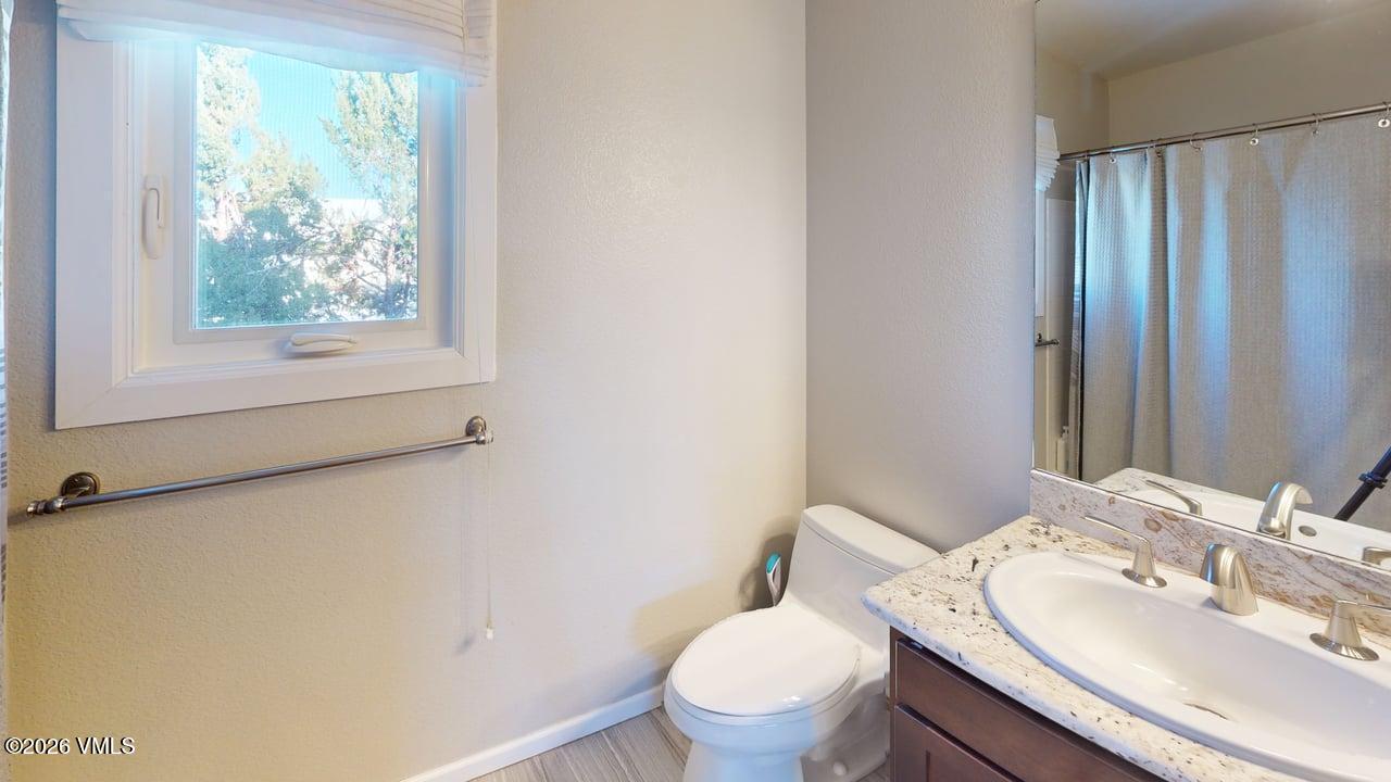 8958 South Forrest Drive Littleton, CO 80126 - Photo 4 of 27 a bathroom with a sink toilet and mirror