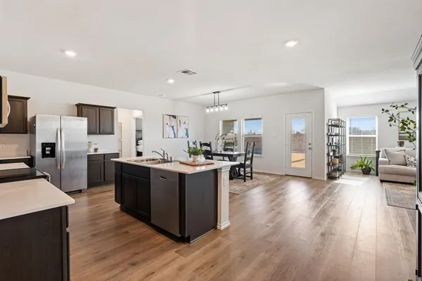 a large kitchen with a table and chairs