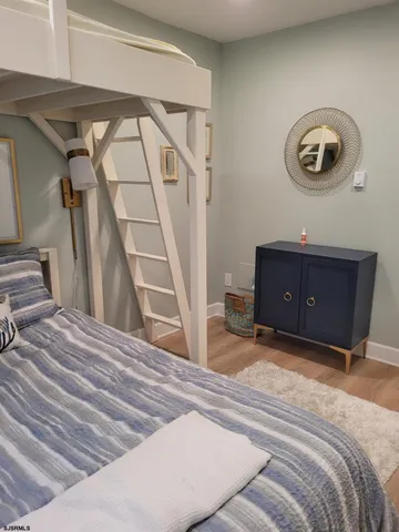 a bedroom with a bed and a mirror