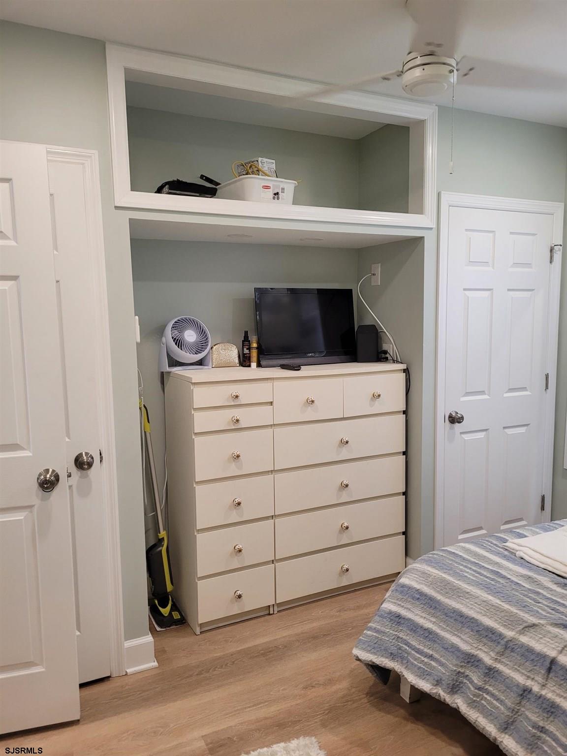 9401 Pacific Avenue, Unit 8 Margate City, NJ 08402 - Photo 7 of 8 a room with a dresser and a window