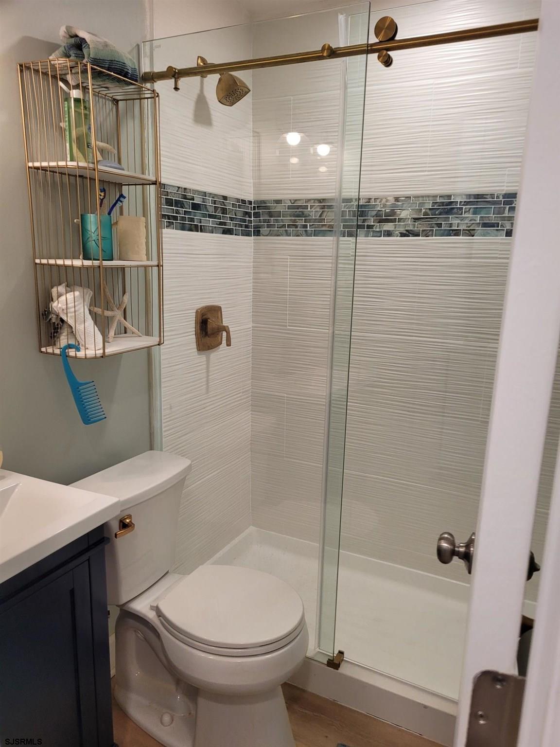 9401 Pacific Avenue, Unit 8 Margate City, NJ 08402 - Photo 8 of 8 a bathroom with a shower a toilet and a sink