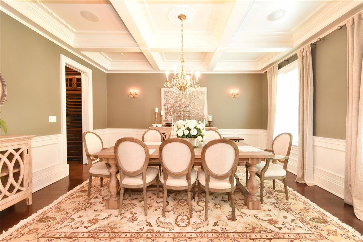 1616 Stewart Lane Syosset, NY 11791 - Photo 12 of 38 Dining room with beam ceiling, a chandelier, coffered ceiling, crown molding, and dark wood-type flooring