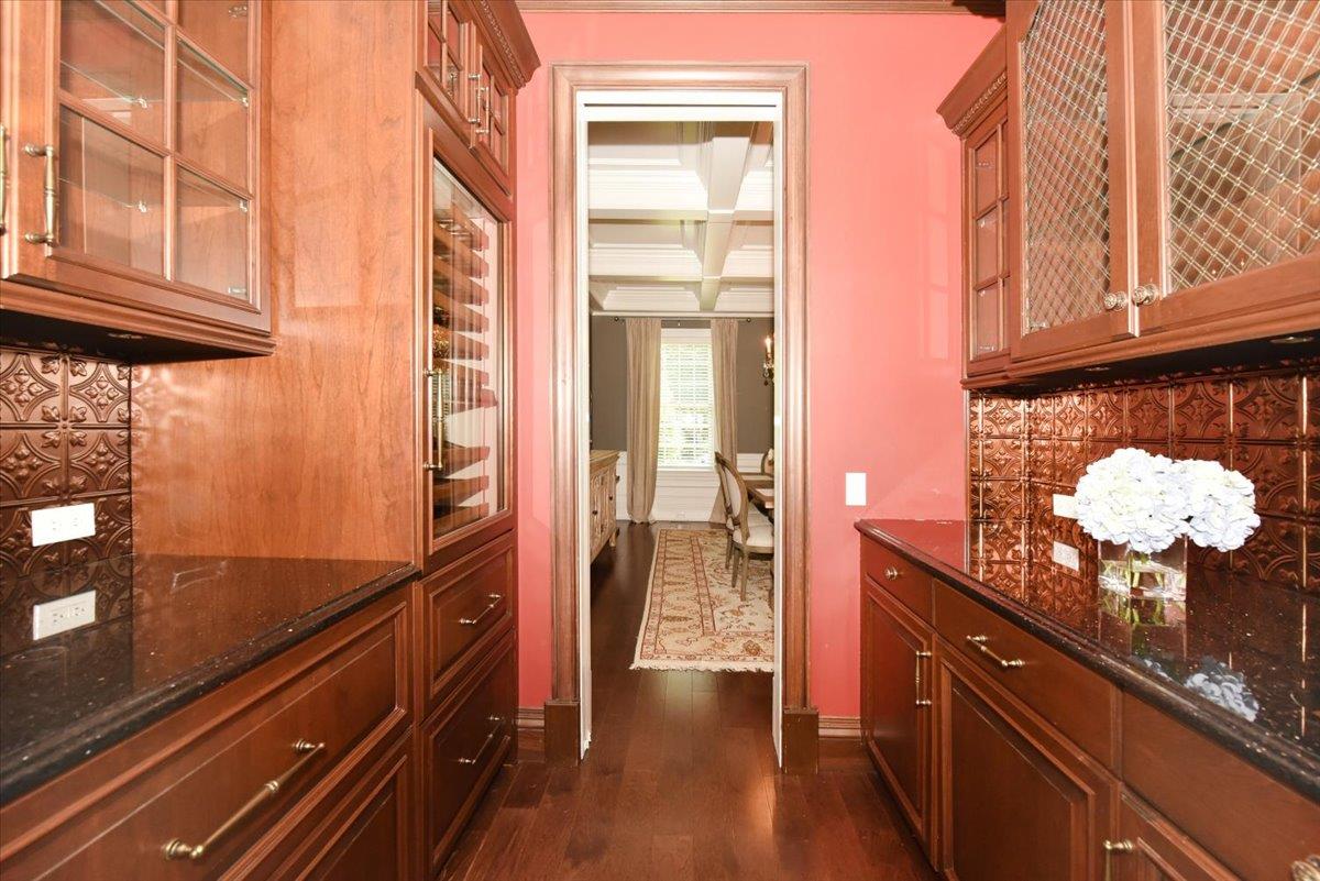 1616 Stewart Lane Syosset, NY 11791 - Photo 13 of 38 Bar area with coffered ceiling, dark wood finished floors, backsplash, and beamed ceiling