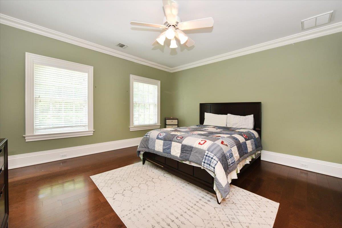 1616 Stewart Lane Syosset, NY 11791 - Photo 28 of 38 Bedroom featuring ornamental molding, wood finished floors, and a ceiling fan