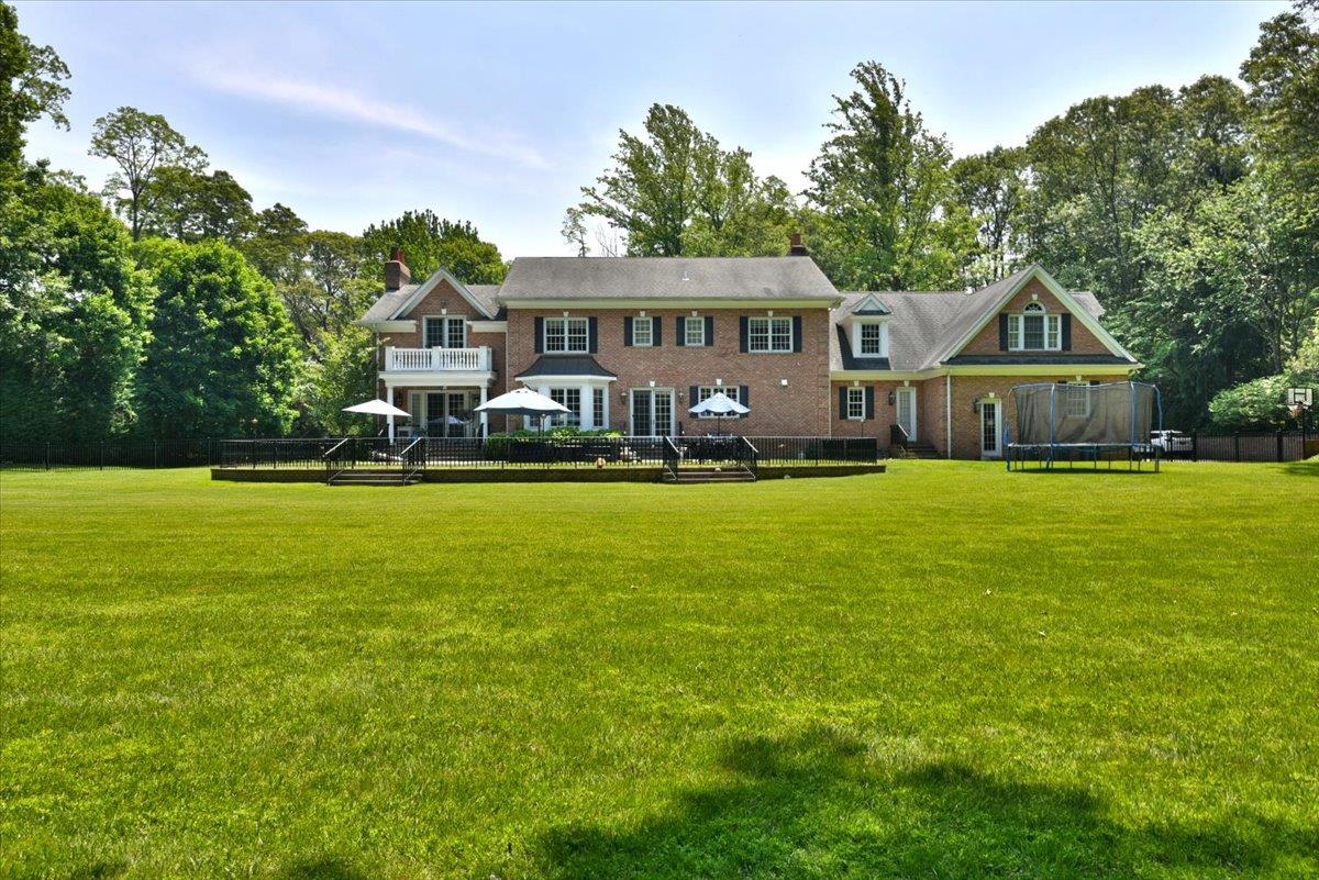 1616 Stewart Lane Syosset, NY 11791 - Photo 32 of 38 Back of property featuring a trampoline, a wooden deck, and a yard