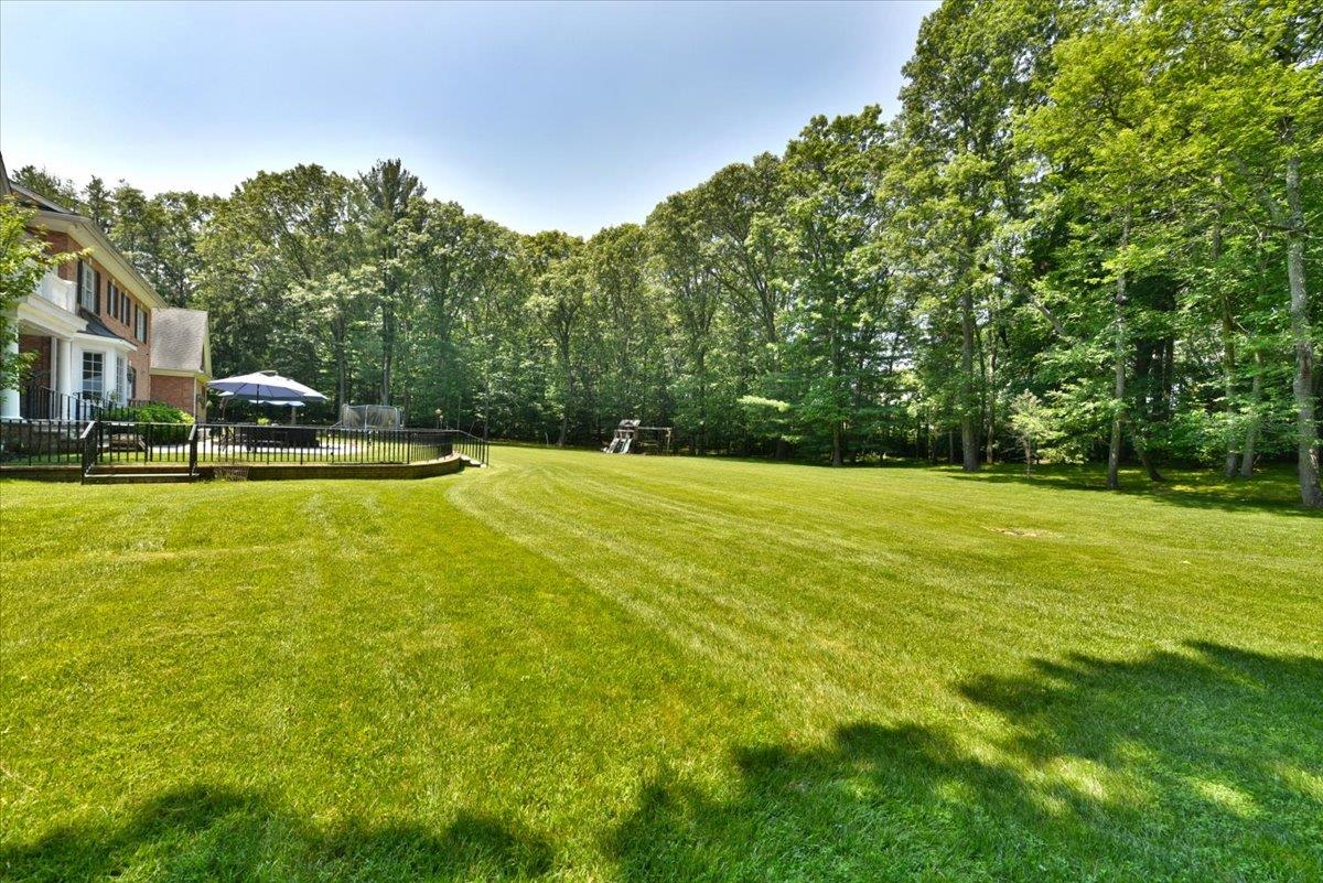1616 Stewart Lane Syosset, NY 11791 - Photo 34 of 38 View of green lawn featuring a wooden deck