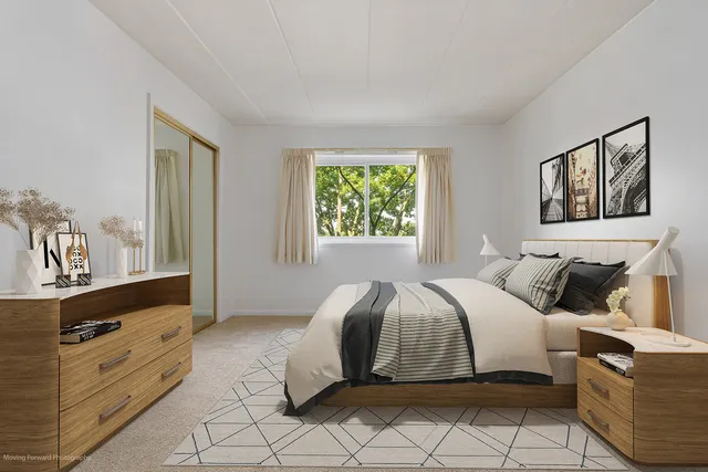 a bedroom with a bed and a dresser