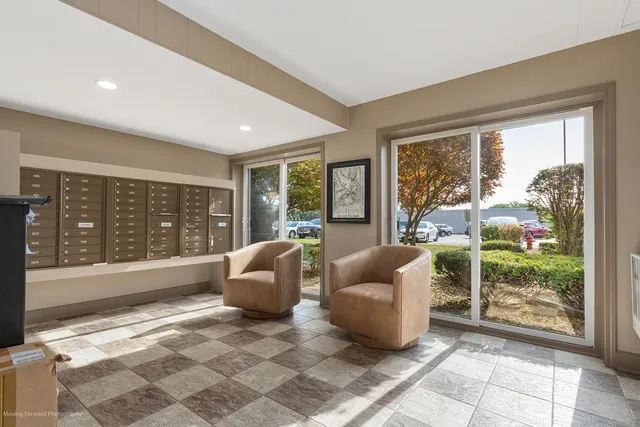 a living room with furniture and large windows