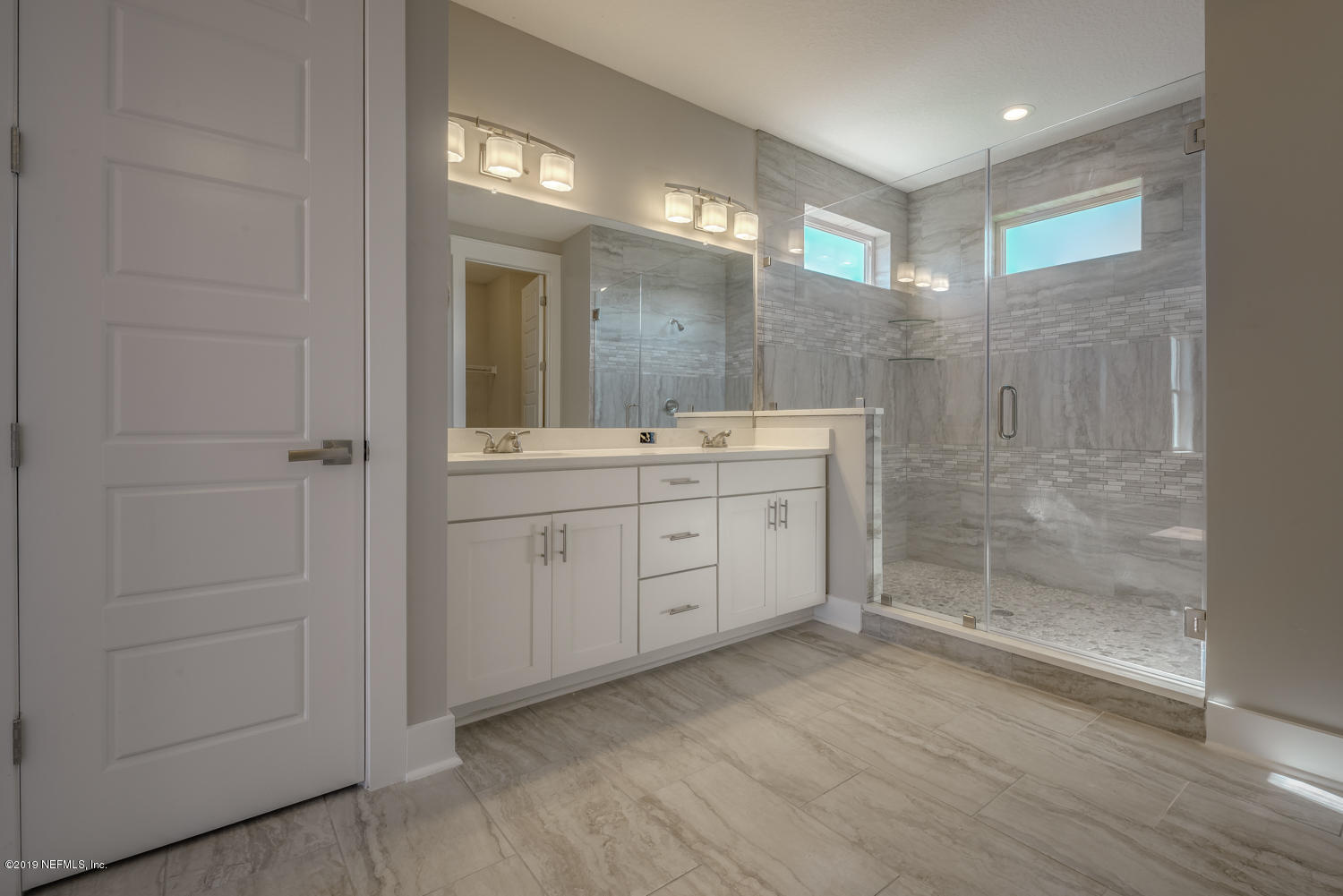 5480 Pelican Way St. Augustine, FL 32080 - Photo 4 of 4 a bathroom with a double vanity sink a toilet and a mirror