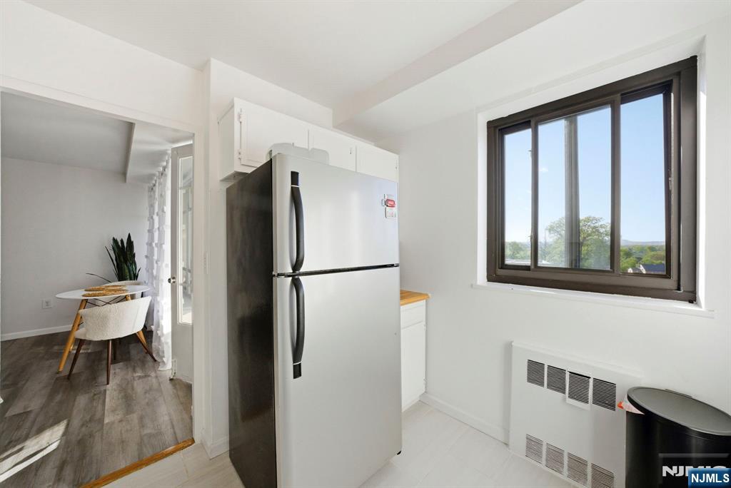 90 Prospect Avenue, Unit 8C Hackensack, NJ 07601 - Photo 11 of 29 a kitchen with a refrigerator and a window