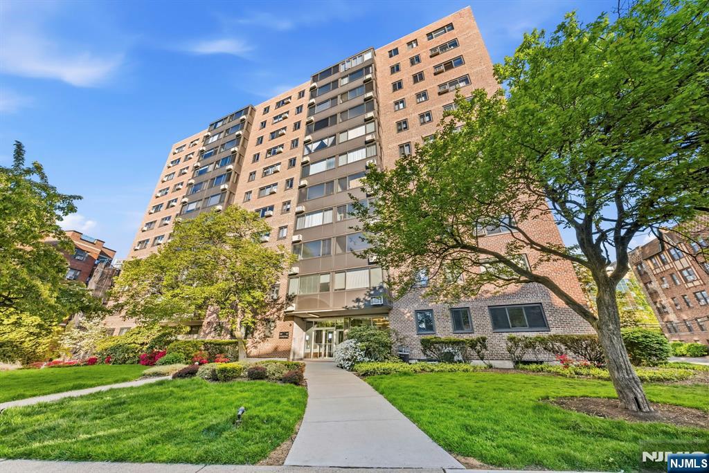 90 Prospect Avenue, Unit 8C Hackensack, NJ 07601 - Photo 25 of 29 front view of a building with a garden