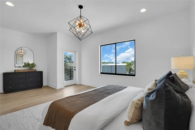 a bedroom with a bed and a chandelier