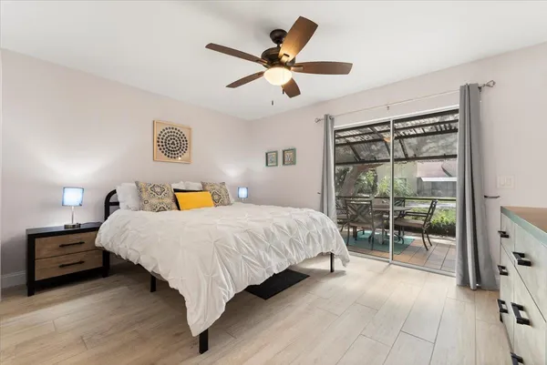 a bedroom with a bed and a table with a bookshelf