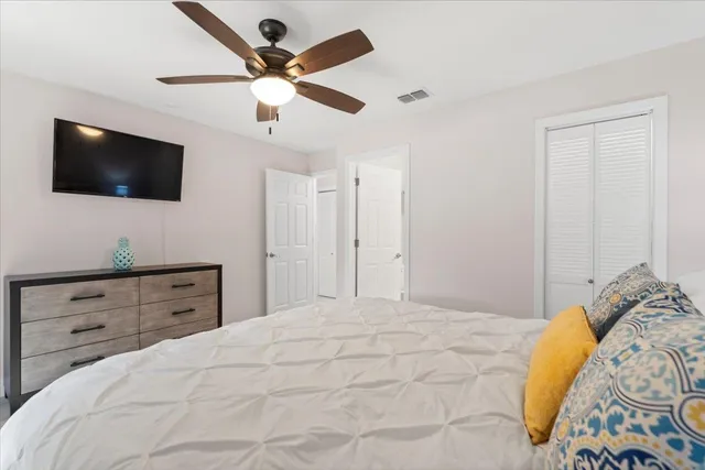 a bedroom with a large bed and a flat screen tv