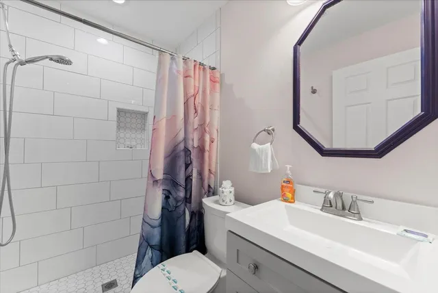 a bathroom with a sink toilet and shower