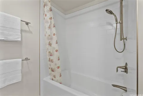 a bathroom with a bath tub with a shower