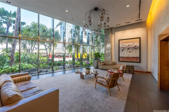 a living room with furniture and a chandelier
