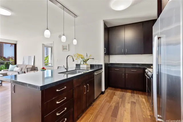 a kitchen with a sink and a refrigerator