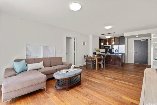 a living room with furniture and a wooden floor