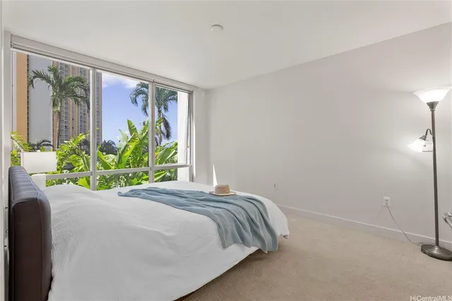a bed sitting in a bedroom next to a window