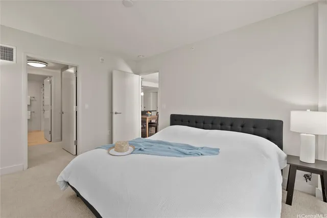 a bedroom with a bed and a lamp