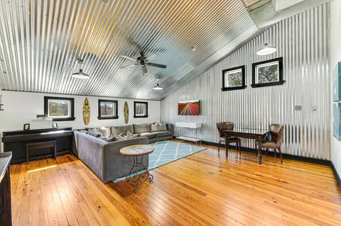 a living room with furniture and a wooden floor