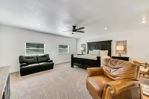 a spacious bathroom with a toilet sink and mirror