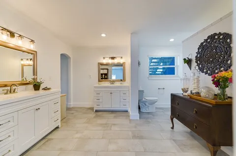 a bedroom with a large bed and a tv